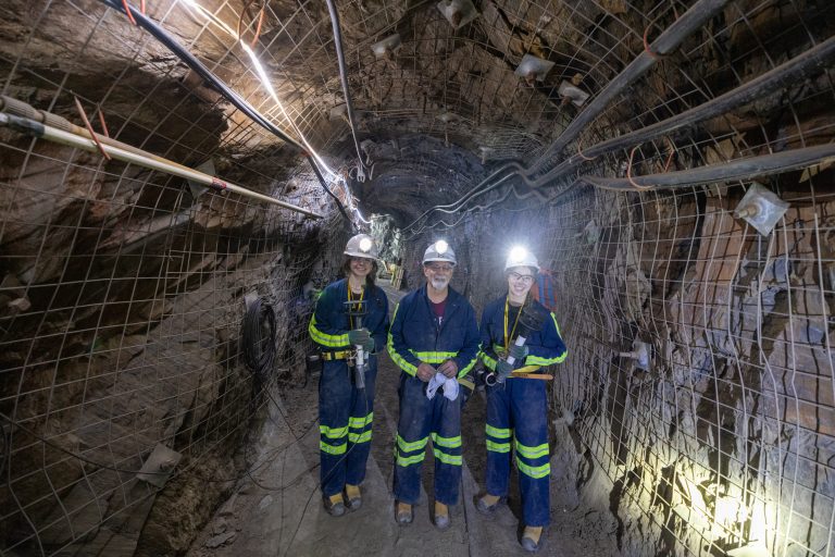 Spearfish High School teacher Steve Gabriel stands with two students inside a drift on the 4850 Level at SURF.