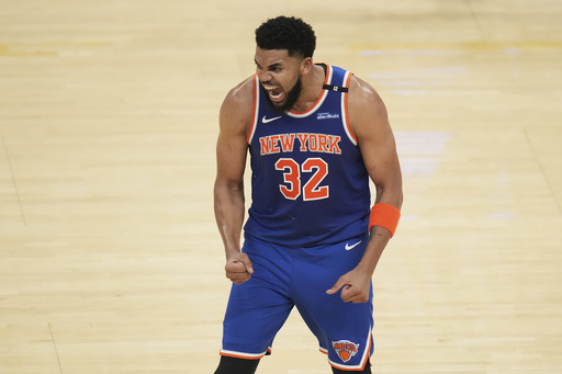 New York Knicks center Karl-Anthony Towns (32) reacts after scoring against the Indiana Pacers during the second half of Game 3 of the Eastern Conference finals of the NBA basketball playoffs Sunday, May 25, 2025, in Indianapolis. (AP Photo/Jeff Roberson)