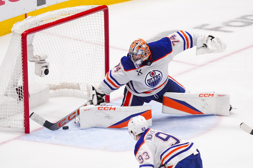 Edmonton Oilers goaltender Stuart Skinner makes a save against the Dallas Stars during the third period in Game 2 of the Western Conference finals in the NHL hockey Stanley Cup playoffs, Friday, May 23, 2025, in Dallas. (AP Photo/LM Otero)