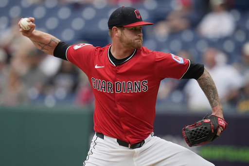Cleveland Guardians' Ben Lively pitches in the first inning of a baseball game against the Milwaukee Brewers in Cleveland, Monday, May 12, 2025. (AP Photo/Sue Ogrocki)