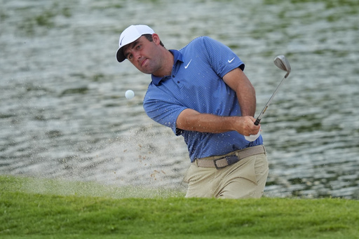 Scottie Scheffler hits out of a bunker on the 18th hole during the first round of the Charles Schwab Challenge golf tournament at Colonial Country Club in Fort Worth, Texas, Thursday, May 22, 2025. (AP Photo/LM Otero)