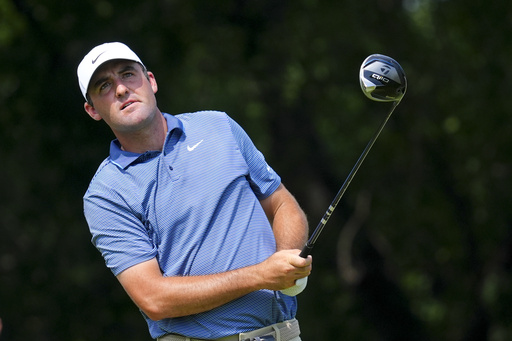 Scottie Scheffler watches a tee shot during the first round of the Charles Schwab Challenge golf tournament at Colonial Country Club in Fort Worth, Texas, Thursday, May 22, 2025. (AP Photo/LM Otero)