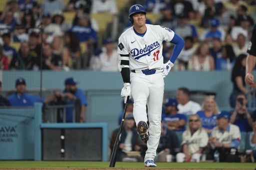 Los Angeles Dodgers' Shohei Ohtani winces after being hit with his own foul ball during the fourth inning of a baseball game against the Arizona Diamondbacks, Wednesday, May 21, 2025, in Los Angeles. (AP Photo/Mark J. Terrill)