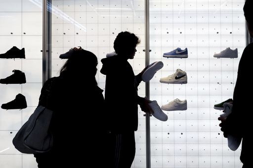 FILE - People shop for shoes in a Nike store on Nov. 25, 2022, in New York. (AP Photo/Julia Nikhinson, File)