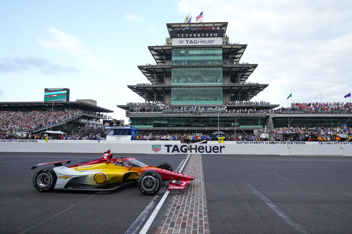 FILE - Josef Newgarden crosses the finish line to win the Indianapolis 500 auto race at Indianapolis Motor Speedway in Indianapolis, Sunday, May 26, 2024. (AP Photo/AJ Mast, file)