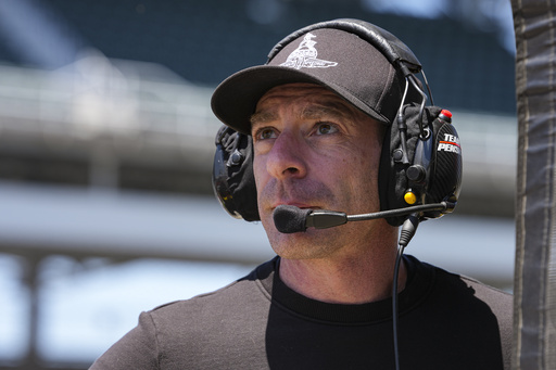 Former Team Penske driver and Indianapolis 500 winner Simon Pagenaud works on the timing stand as a driver coach for Scott McLaughlin during practice for the Indianapolis 500 auto race at Indianapolis Motor Speedway in Indianapolis, Sunday, May 18, 2025. (AP Photo/Michael Conroy)