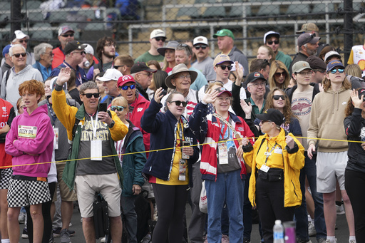 Fans waive during parade laps before the start of the Indianapolis 500 auto race at Indianapolis Motor Speedway in Indianapolis, Sunday, May 25, 2025. (AP Photo/AJ Mast)