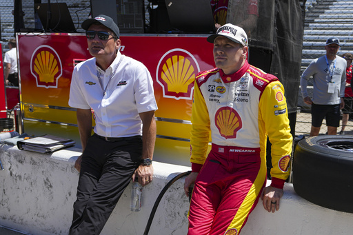 President of Team Penske Tim Cindric, left and driver Josef Newgarden wait for the start of during practice for the Indianapolis 500 auto race at Indianapolis Motor Speedway in Indianapolis, Sunday, May 18, 2025. (AP Photo/Michael Conroy)