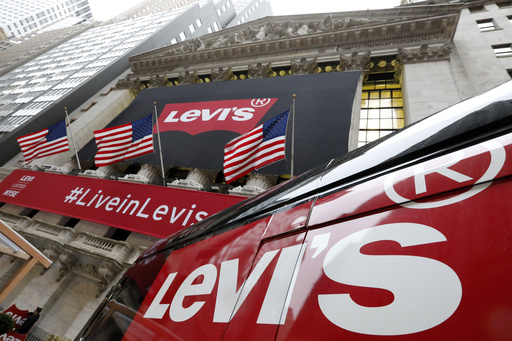FILE - A Levi's banner adorns the facade of the New York Stock Exchange, Thursday, March 21, 2019. (AP Photo/Richard Drew, File)