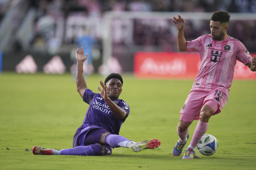 Orlando City defender Alex Freeman, left, clears the ball to stop a scoring attempt by Inter Miami defender Jordi Alba (18) during the first half of an MLS soccer match, Sunday, May 18, 2025, in Fort Lauderdale, Fla. (AP Photo/Rebecca Blackwell)