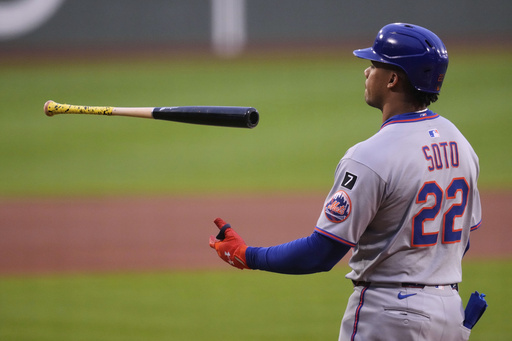 New York Mets' Juan Soto flips his bat after striking out against Boston Red Sox pitcher Walker Buehler during the first inning of a baseball game at Fenway Park, Tuesday, May 20, 2025, in Boston. (AP Photo/Charles Krupa)