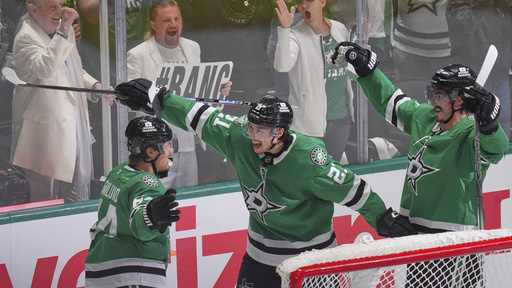 Dallas Stars center Mikael Granlund (64) celebrates a goal with teammates Jason Robertson (21) and Mason Marchment during the third period in Game 1 of the Western Conference finals in the NHL hockey Stanley Cup playoffs against the Edmonton Oilers, Wednesday, May 21, 2025, in Dallas. (AP Photo/LM Otero)