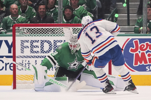 Edmonton Oilers center Mattias Janmark (13) scores against Dallas Stars goaltender Jake Oettinger (29) during the first period of Game 5 of the Western Conference finals in the NHL hockey Stanley Cup playoffs, Thursday, May 29, 2025, in Dallas. (AP Photo/Julio Cortez)