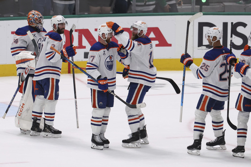 Edmonton Oilers players celebrate after winning Game 5 of the Western Conference finals in the NHL hockey Stanley Cup playoffs against the Dallas Stars, Thursday, May 29, 2025, in Dallas. (AP Photo/Gareth Patterson)