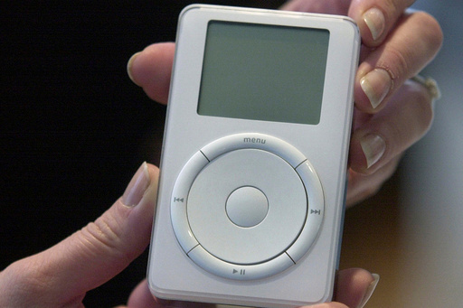 FILE - Apple's digital music player, iPod, is displayed after its introduction by Apple Computer Inc. chief executive officer Steve Jobs during a news conference, Oct. 23, 2001, in Cupertino, Calif. (AP Photo/Julie Jacobson, File)