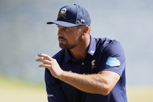 Bryson DeChambeau waves after making a putt on the 14th hole during the final round of the PGA Championship golf tournament at the Quail Hollow Club, Sunday, May 18, 2025, in Charlotte, N.C. (AP Photo/Matt York)