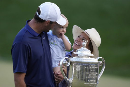 Scottie Scheffler, wife Meredith pose with their son Bennett after winning the PGA Championship golf tournament at the Quail Hollow Club, Sunday, May 18, 2025, in Charlotte, N.C. (AP Photo/Matt York)