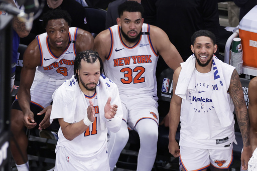 New York Knicks guard Jalen Brunson (11), forward OG Anunoby (8), center Karl-Anthony Towns (32) and guard Cameron Payne (1) react during the fourth quarter of Game 5 of the NBA basketball Eastern Conference finals against the Indiana Pacers, Thursday, May 29, 2025, in New York. (AP Photo/Adam Hunger)