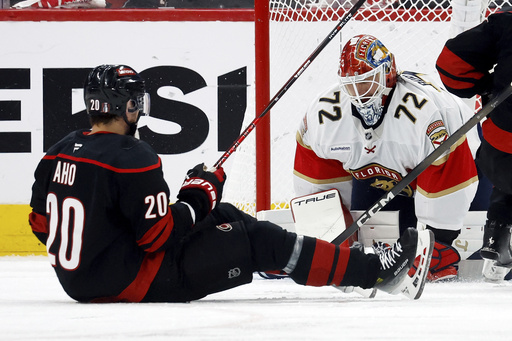 Carolina Hurricanes' Sebastian Aho (20) has his shot frozen by Florida Panthers goaltender Sergei Bobrovsky (72) during the third period of Game 1 of the NHL hockey Stanley Cup Eastern Conference finals in Raleigh, N.C., Tuesday, May 20, 2025. (AP Photo/Karl DeBlaker)