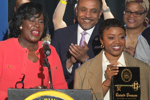 In this image made from video, Philadelphia's Mayor Cherelle Parker, left, honors actor Quinta Brunson with a key to the city in a ceremony dedicating a mural at Brunson’s alma mater, Andrew Hamilton School, which was the inspiration for her award-winning show “Abbott Elementary” Wednesday, May 28, 2025, in Philadelphia. (AP Photo/Tassanee Vejpongsa)