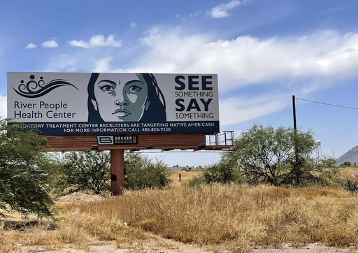FILE - A billboard is seen in Scottsdale, Ariz., Saturday, June 10, 2023, near the health care facility of the Salt River Pima-Maricopa Indian Community, which has been affected by a gigantic Medicaid fraud scheme involving sober living homes that promised help to Native Americans seeking to kick alcohol and other additions. (AP Photo/Anita Snow, File)