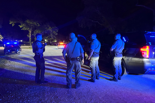 In this photo provided by the Horry County Police Department, police officers respond to the scene of a shooting on Sunday, May 25, 2025, in Little River, S.C. (Horry County Police Department via AP)