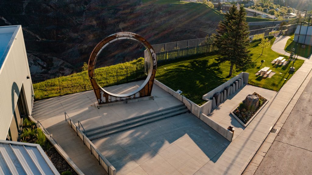 An aerial shot overlooking the Sanford Lab Homestake Visitor Center and the Davis Ring in Lead, SD.