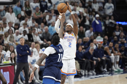 Oklahoma City Thunder guard Shai Gilgeous-Alexander (2) shoots against Minnesota Timberwolves center Naz Reid during the second half of Game 4 of the Western Conference finals of the NBA basketball playoffs Monday, May 26, 2025, in Minneapolis. (AP Photo/Abbie Parr)