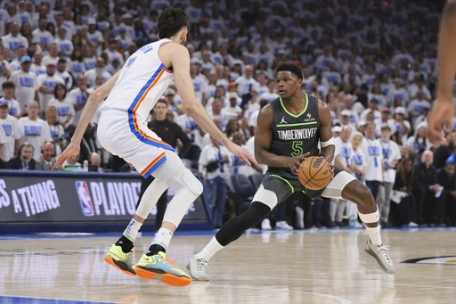 Minnesota Timberwolves guard Anthony Edwards (5) works the floor against Oklahoma City Thunder forward Chet Holmgren during the first half of Game 1 of an NBA basketball Western Conference Finals playoff series Tuesday, May 20, 2025, in Oklahoma City. (AP Photo/Nate Billings)