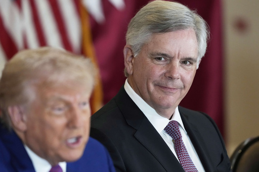 President Donald Trump speaks as Larry Culp, CEO of GE Aerospace smiles during a business roundtable, Thursday, May 15, 2025, in Doha, Qatar. (AP Photo/Alex Brandon)