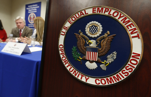 FILE - The emblem of the U.S. Equal Employment Opportunity Commission (EEOC) is shown on a podium in Vail, Colorado, Feb. 16, 2016, in Denver. (AP Photo/David Zalubowski, File)