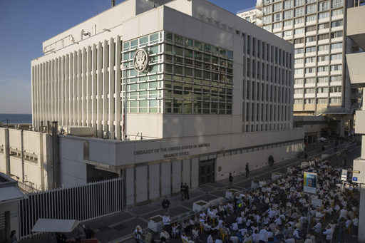 FILE - Activists sit in front of the U.S. Embassy branch office in Tel Aviv, Israel, during a protest, Wednesday, Jan. 8, 2025. (AP Photo/Ohad Zwigenberg, File)