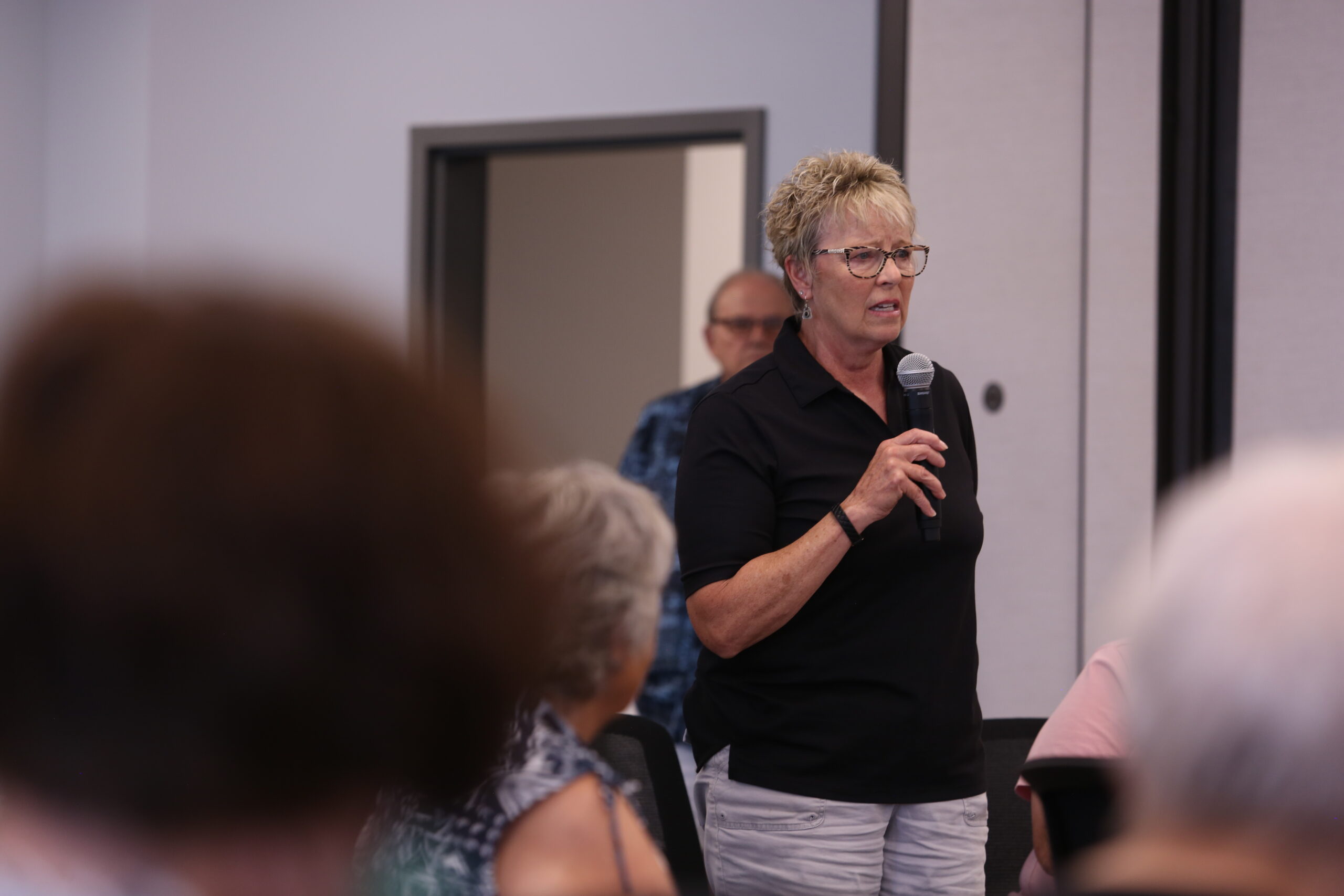 Colleen Werner, a former educator and school administrator in Sioux Falls, speaks during a state Department of Social Services public hearing regarding cuts to TANF benefits at the Sioux Falls One Stop on June 20, 2025. (Makenzie Huber/South Dakota Searchlight)