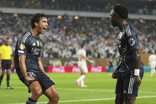 Real Madrid's Vinicius Junior celebrates with teammate Gonzalo Garcia, left, after scoring his team's first goal during the Club World Cup Group H soccer match between Salzburg and Real Madrid in Philadelphia, Thursday, June 26, 2025. (AP Photo/Matt Slocum)