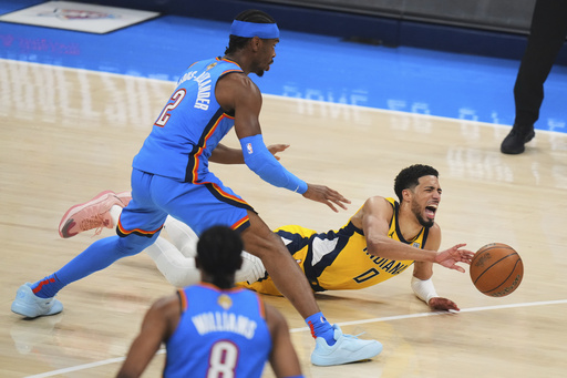 Indiana Pacers guard Tyrese Haliburton (0) falls to the court with an injury during the first half of Game 7 of the NBA Finals basketball series against the Oklahoma City Thunder Sunday, June 22, 2025, in Oklahoma City. (AP Photo/Nate Billings)