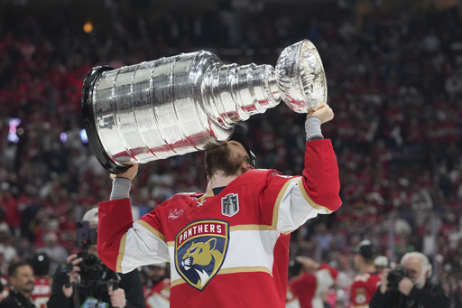 Florida Panthers center Sam Reinhart (13) kisses the Stanley Cup after defeating the Edmonton Oilers in Game 6 of the NHL hockey Stanley Cup Final Tuesday, June 17, 2025, in Sunrise, Fla. (AP Photo/Lynne Sladky)