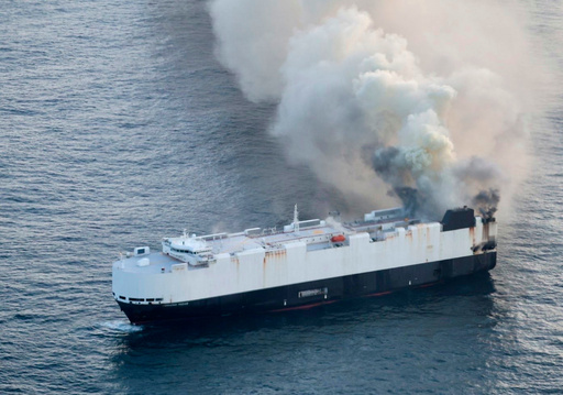 In this photo provided by the U.S. Coast Guard, smoke rises from cargo vessel Morning Midas approximately 300 miles south of Adak, Alaska, June 3, 2025, as the crew of a cargo ship carrying around 3,000 vehicles to Mexico, abandoned ship after they could not control a fire. (U.S. Coast Guard/Courtesy Air Station Kodiak via AP)