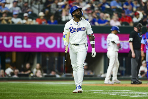 Texas Rangers' Adolis García looks up at a video display after striking out during the fifth inning of a baseball game against the Toronto Blue Jays Wednesday, May 28, 2025, in Arlington, Texas. (AP Photo/Ronaldo Bolaños)