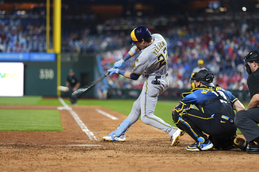 Milwaukee Brewers' Christian Yelich hits a home run against Philadelphia Phillies pitcher Carlos Hernández during the ninth inning of a baseball game Friday, May 30, 2025, in Philadelphia. (AP Photo/Matt Slocum)