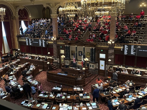 Color-coordinated Iowans advocating for and against a massive carbon-capture pipeline project routed across several Midwest states await a debate among lawmakers at the statehouse in Des Moines on Monday, May 12, 2025. (AP Photo/Hannah Fingerhut)
