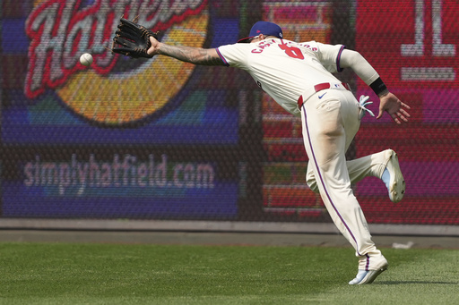 Philadelphia Phillies right fielder Nick Castellanos can't reach a triple hit by Chicago Cubs' Ian Happ during the eighth inning of a baseball game Wednesday, June 11, 2025, in Philadelphia. (AP Photo/Matt Slocum)