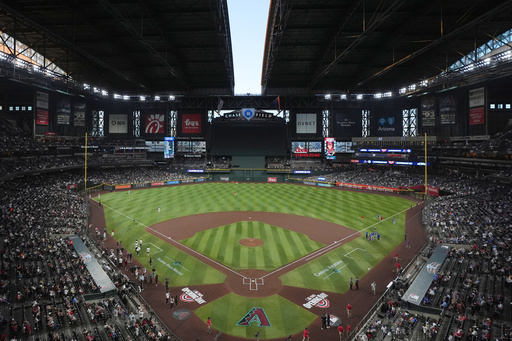 FILE - The roof to Chase Field begins to open prior to an opening-day baseball game between the Arizona Diamondbacks and the Chicago Cubs, March 27, 2025, in Phoenix. (AP Photo/Ross D. Franklin, File)