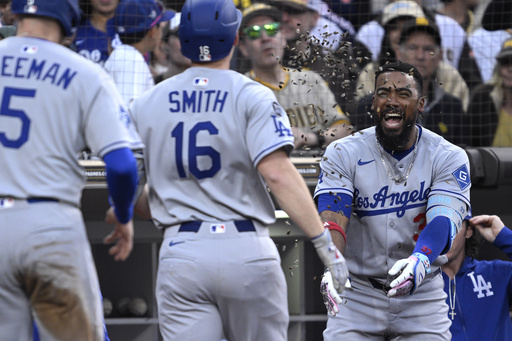 Los Angeles Dodgers' Will Smith (16) has sunflower seeds tossed at him by Teoscar Hernandez, right, after hitting a two-run home run against the San Diego Padres during the third inning of a baseball game Monday, June 9, 2025, in San Diego. (AP Photo/Orlando Ramirez)