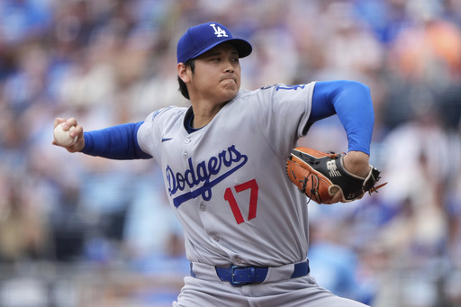 Los Angeles Dodgers starting pitcher Shohei Ohtani throws during the first inning of a baseball game against the Kansas City Royals, Saturday, June 28, 2025, in Kansas City, Mo. (AP Photo/Charlie Riedel)