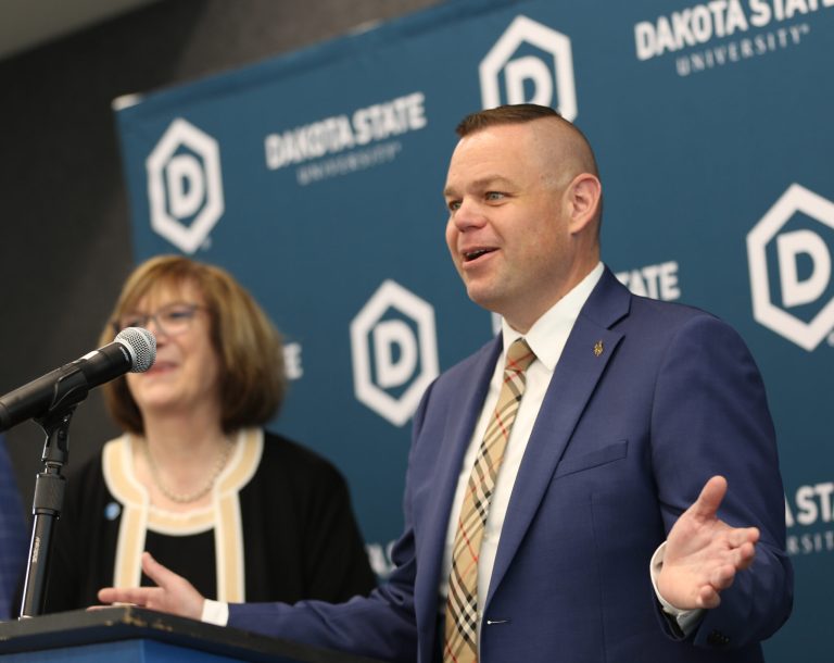 Reid Rasner, who says he’s pulled together a $47.45 billion bid for TikTok, speaks on May 23, 2025, at Dakota State University in Madison. At left is DSU President José-Marie Griffiths. (John Hult/South Dakota Searchlight)