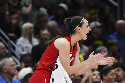 Indiana Fever guard Caitlin Clark claps from the bench during the second half of a WNBA basketball game against the Seattle Storm, Tuesday, June 24, 2025, in Seattle. (AP Photo/Lindsey Wasson)