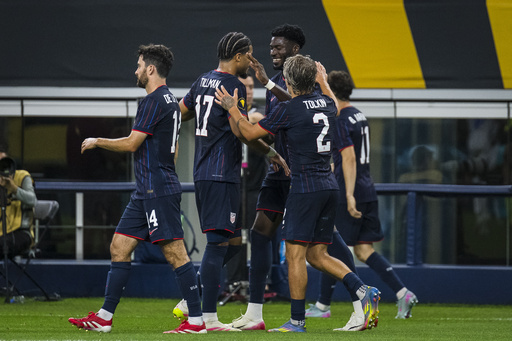 United States forward Patrick Agyemang (24), center right, is congratulated by teammates after scoring a goal during a CONCACAF Gold Cup soccer match against Haiti, Sunday, June 22, 2025, in Arlington, Texas. (AP Photo/Jessica Tobias)