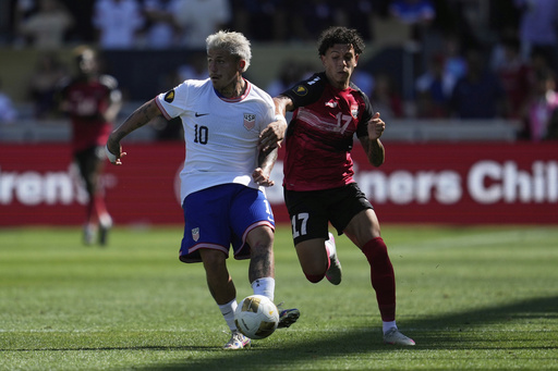 United States midfielder Diego Luna (10) brings the ball up the field against Trinidad and Tobago forward Rio Cardines (17) during the second half of a CONCACAF Gold Cup soccer match in San Jose, Calif., Sunday, June 15, 2025. (AP Photo/Jeff Chiu)