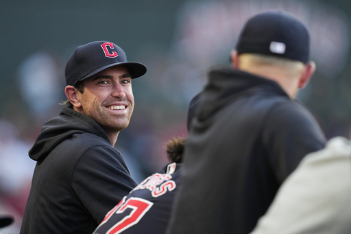 FILE - Cleveland Guardians' Shane Bieber stands in the dugout during the third inning of a baseball game against the Los Angeles Angels in Anaheim, Calif., May 25, 2024. (AP Photo/Ashley Landis, file)