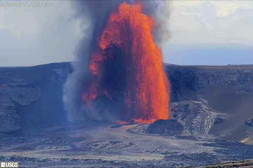 This image from webcam footage provided by the United States Geological Survey (USGS) shows lava fountains shooting up high in the latest episode of an ongoing eruption of Kilauea volcano inside Hawaii Volcanoes National Park on Wednesday, June 11, 2025. (United States Geological Survey via AP)